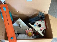 Box with Snoopy Doghouse View-Master toy, loose parts, and Duncad yo-yo packaging, blue Peanuts slide viewer visible