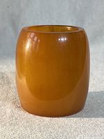 Front view of vintage amber Bakelite small bowl showing smooth polished surface and rounded top edge