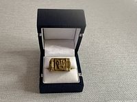 Ring displayed in black and white jewelry box