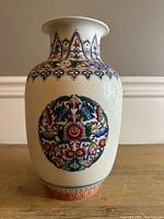 Front view of the vase showing the full front medallion and upper rim decoration