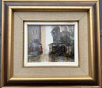 Framed oil painting showing entire urban alley scene with buildings, fence, tree, and figure with red umbrella.