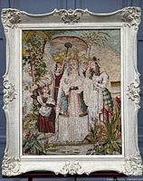 Full view of the framed embroidery showing the scene and frame details