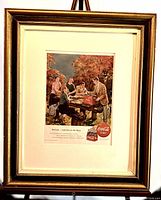Full view of framed vintage Coca-Cola magazine advertisement showing the entire framed piece with a gold-tone frame and white matting.