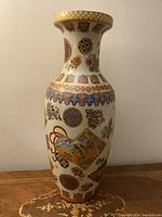 Full view of vintage tall Satsuma style hand painted vase, showcasing its shape and overall painted design.