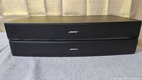 Two stacked Bose Solo TV sound systems showing front side with Bose logo on grille