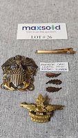 Top view of military badges and medal ribbon bar with MaxSold lot card
