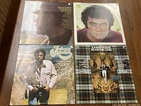 Four Johnny Mathis vinyl record albums laid out showing cover art, including profile and frontal portraits and thematic scenes.