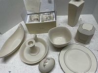 Eight assorted Lenox tabletop decor pieces displayed in white background including candle holders, vases, bowls, plates, and decorative items.