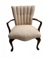 Front view of mid-century channel back arm chair showing upholstery and Queen Anne legs.