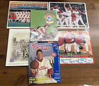 Lot overview photo showing all three posters and three magazines arranged on a surface.