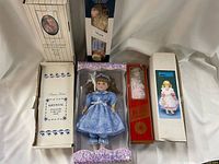Six dolls in original packaging, showing various boxes and doll designs including Krystal doll and blue-dressed doll