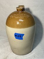 Front view of the antique jug showing two-tone glaze and blue sticker #24.