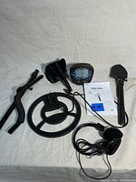 Full set including MD-830 metal detector components: coil, adjustable shaft, control panel, headphones, shovel, and manual.