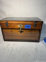 Front view of the wooden vintage machinist tool chest showing front latches and glass front panel