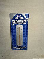 Front view of the vintage Pabst Blue Ribbon Beer thermometer showing full product design and temperature scale.