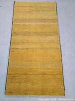 Full view of canary yellow rug on floor