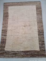 Top down view of rug on flat surface showing full design