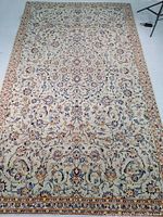 Full view of rug laid flat showing overall pattern and field color