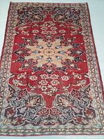 Full view of the hand knotted Persian Lilian wool rug showing large decorative central floral medallion and border pattern in subdued colors.