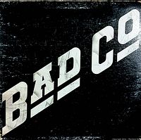 Close-up photo of the front cover of the vintage Bad Company vinyl record album, showing the band's name in large silver lettering on black background with visible wear marks.