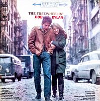 Front cover of 'The Freewheelin' Bob Dylan' vinyl record showing Bob Dylan and woman walking on a street with vintage cars. Shows condition and cover artwork.