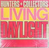 Front cover of the vinyl record showing the band name 'Hunters + Collectors' and album title 'Living Daylight' with visible wear on the cover.