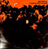 Front cover of the vintage vinyl record titled Ciquri/Detached by Material, showing orange and black artwork and visible wear including a tear on the cover.