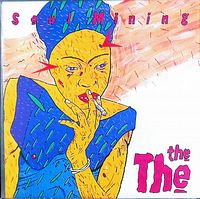 Close-up of the vintage vinyl record cover 'Soul Mining' by The The, featuring colorful artwork and some wear to the edges.