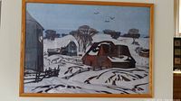 Front view of framed AJ Casson print showing winter barn scene under glass in wood frame.