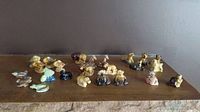 Overview of 24 Wade ceramic animal figurines on a display surface