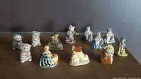 Full view of all 12 Wade Nursery Rhymes figurines arranged on a surface showing varying characters including animals and people.