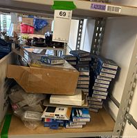 Shelf with stacked ink cartridge boxes including multiple G&G brand ink cartridges and other brands