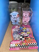 Photo showing two TY Beanie Babies (blue and pink bears) in protective boxes and a Super Strawberry Fashion Pack toy in unopened packaging.