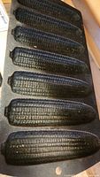 Close-up photo of the cast iron corn bread mold featuring six corn cob shaped molds in a single piece of cast iron