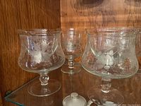 Close-up of etched crystal shrimp bowls showing floral etching and detail on stem and bowl shape.