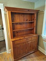 Front view of solid wood Amish farmhouse buffet and hutch with open shelves, drawers and cabinet storage.