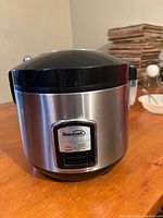 Front view of Beaumark rice cooker showing stainless steel body and control panel.