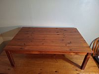 Top view of large rectangular wooden coffee table showing the natural wood surface and finish.