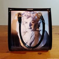Front view of handbag showing the first holographic image of Marilyn Monroe in black and white portrait.