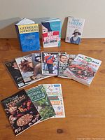 Photo showing hardcover books Alcoholics Anonymous, Not Working, Rosie Harris, plus several People magazines and cookbooks The Gluten-Free Idiot Cookbook, Herbal Kitchen, Fun with Mushrooms, and Making Holiday Stories.