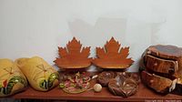 Wide view showing all items in the lot including Dutch shoes, maple leaf shelves, chicken game, candy dish, and jewelry case
