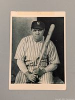 Full view of postcard featuring Babe Ruth in Yankees uniform holding a bat.