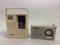 Two vintage Panasonic transistor radios side by side - model R-1493C larger with handle and vertical dial, model R-1241 smaller with circular dial.