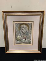 Front view of framed silver religious art featuring mother and child with color added, showing overall condition.