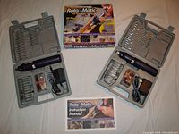 Two Roto-Matic cordless rechargeable high-speed rotary tool sets displayed with cases open showing tools and accessories, plus instruction manuals.