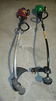 Two gas-powered weed trimmers, one red and silver (Weed Eater W25CBK) with curved shaft and loop handle, and one green and black (Homelite UT20022A) with straight shaft and loop handle.