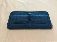 Front view of the Lug Double Kickflip wallet in ocean blue, showing quilted fabric and two flap pockets.
