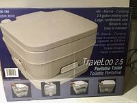 Front view of TravelLoo 2.5 gallon portable toilet box showing product features like large, comfortable seat, 2.5 gallon holding tank, suitable for RV, marine, camping. Color tan/beige.