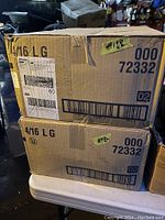 Two cardboard boxes labeled with product barcode and size L markings, stacked on each other.