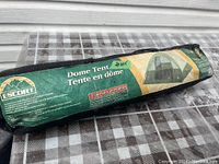 Photo of the 3 person dome tent in its original packaging carrying bag. The bag is green with graphics and brand name Escort clearly displayed.
